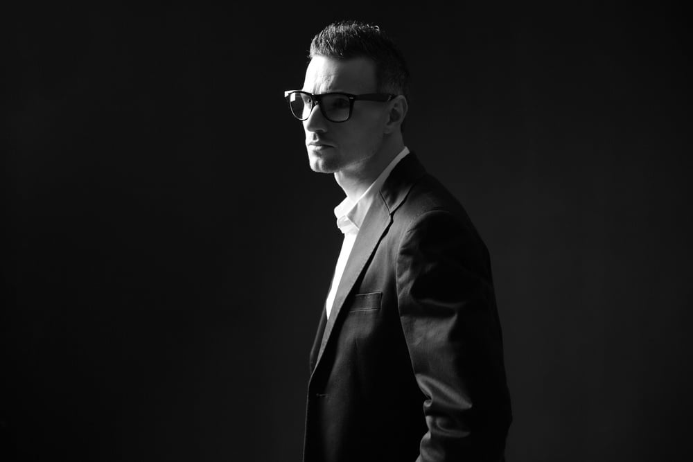 Black and white photo of a thoughtful businessman in glasses Black and white photo of a thoughtful businessman in glasses